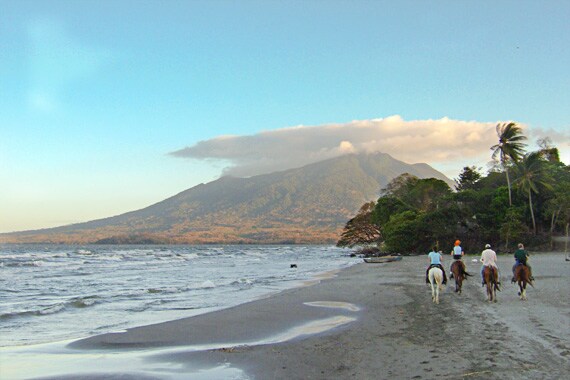 On Ometepe Island, Playa Santo Domingo's long sandy coastline is one of the prettiest freshwater beaches in Nicaragua with the forest-covered Maderas Volcano looming at the beach's end.