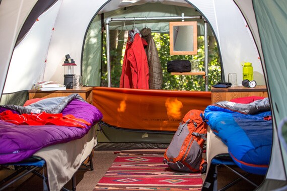 Private tent sites feature covered outdoor seating, perfect for relaxing after a big day.