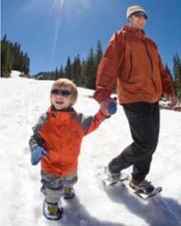 Kid learning how to snowshoe