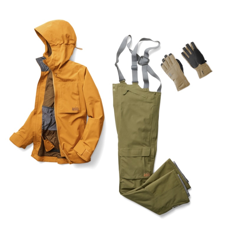 R E I Co-op brand snow jacket, bib overall snow pants, and gloves from the First Chair collection are shown against a transparent background
