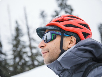 A climber rests while on a winter expedition.