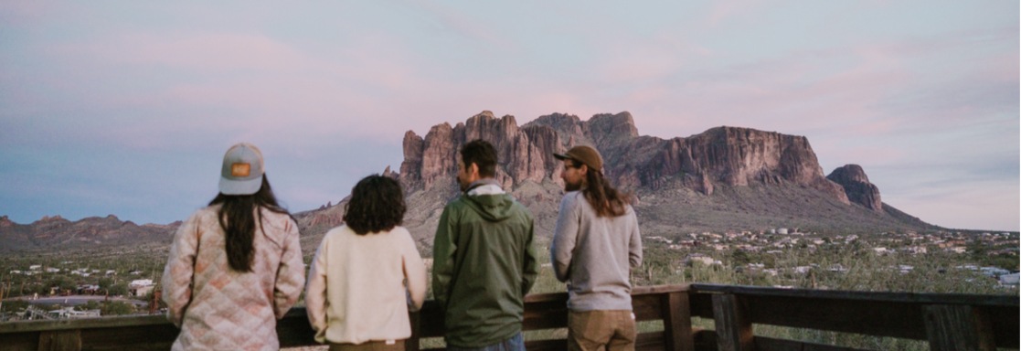 a group of people gazing at the mountains