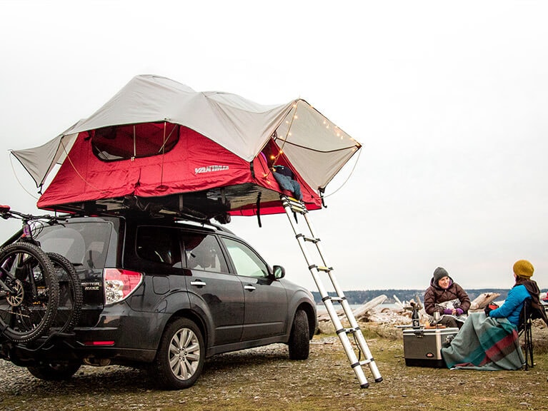 A Yakima Skyrise rooftop tent fully assembled on a S U V