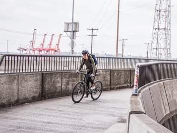 Cycling past an industrial waterfront