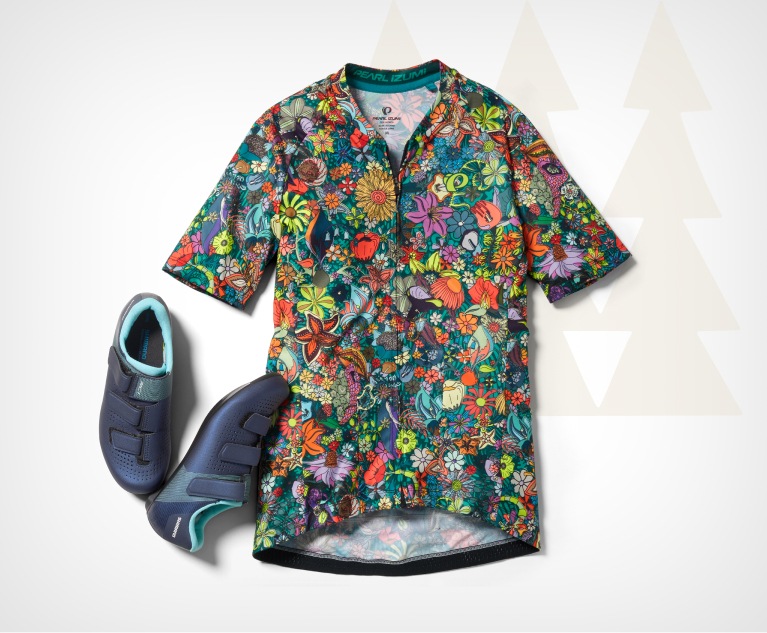 A cycling jersey with a vibrant floral print and a pair of cycling shoes.