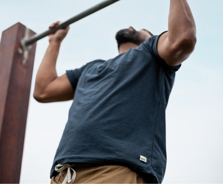 A person does a pull-up outside