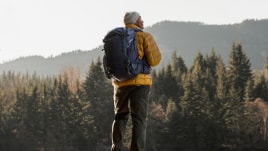 Pausing during a hike to enjoy the view of a alpine lake.