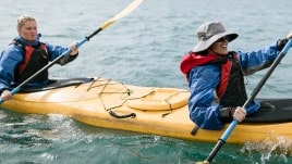 Paddling a tandem kayak in a mountain lake.