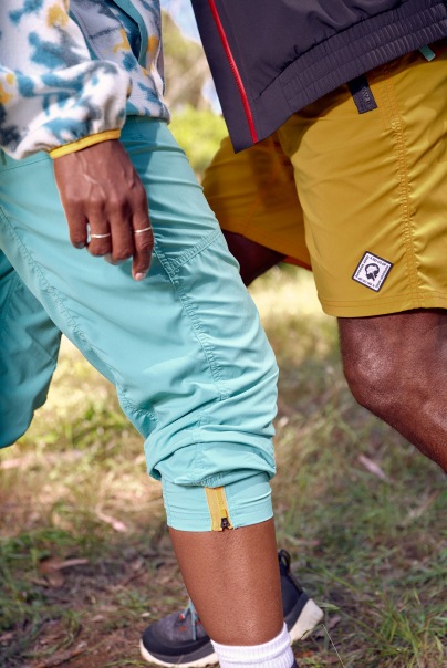 Two people in hiking clothing from the Outdoor Afro Inc. + R E I Co-op collection.
