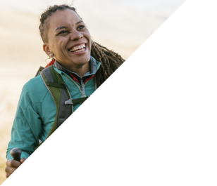 Smiling broadly, a hiker enjoys sunshine and fresh air.