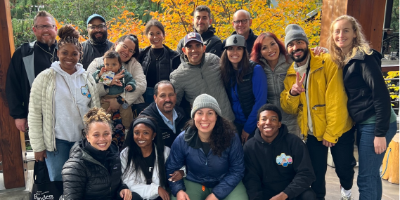 Participants in the Navigate program and leaders of Path Ahead Ventures gather outside of the R E I Co-op flagship store in Seattle, Washington.