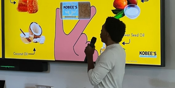 Kobe Harris, founder and C E O of KOBEESCO and a 2022 Navigate cohort participant, presents to his fellow founders about his products’ natural ingredients.