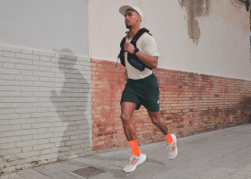 A runner jogs through a city setting.