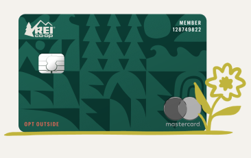 A green credit card with an illustration of a flower growing.