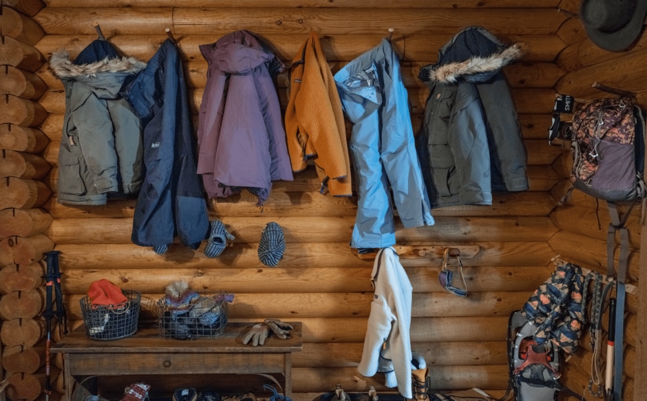 Set of jackets hung on a wooden wall