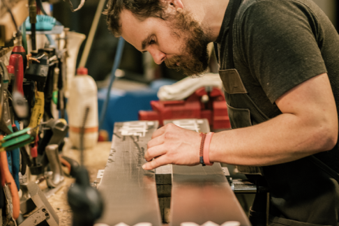 REI employee looking closely at a pair of skis