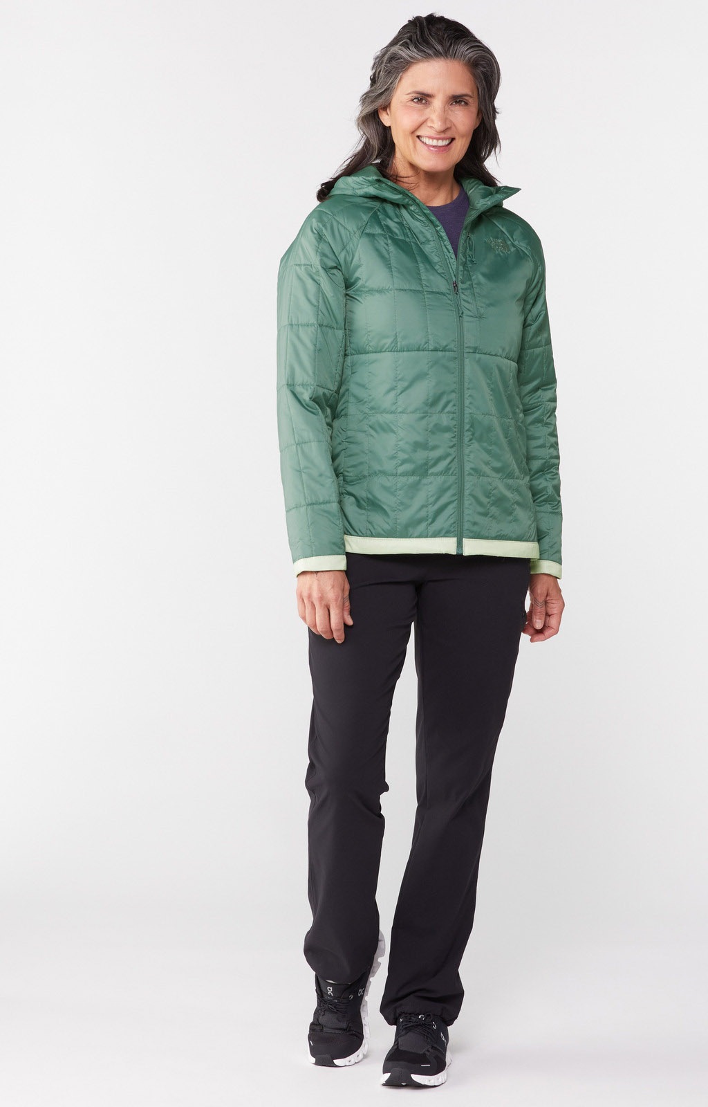 A model with shoulder-length gray hair wears a green Circaloft jacket by The North Face