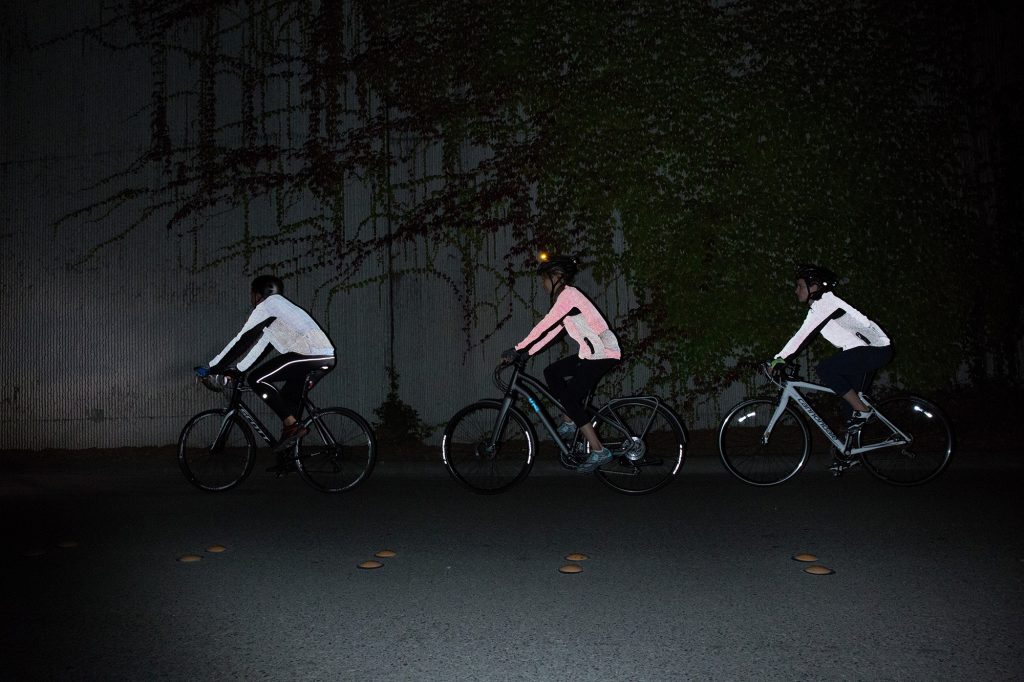 Group of cyclists riding at night