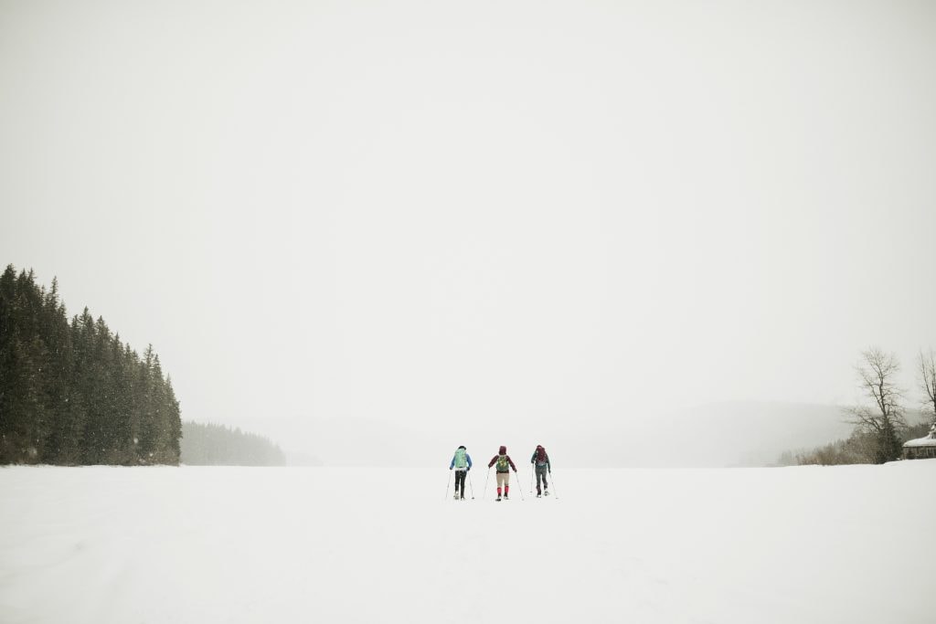 Three people walking in the snow