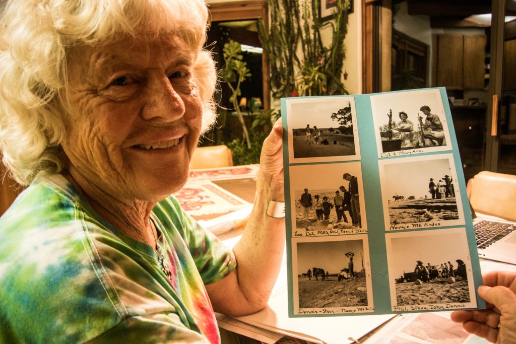 Ada holds up black-and-white photos of the summer she spent working on the Glen Canyon Salvage Project in 1962.