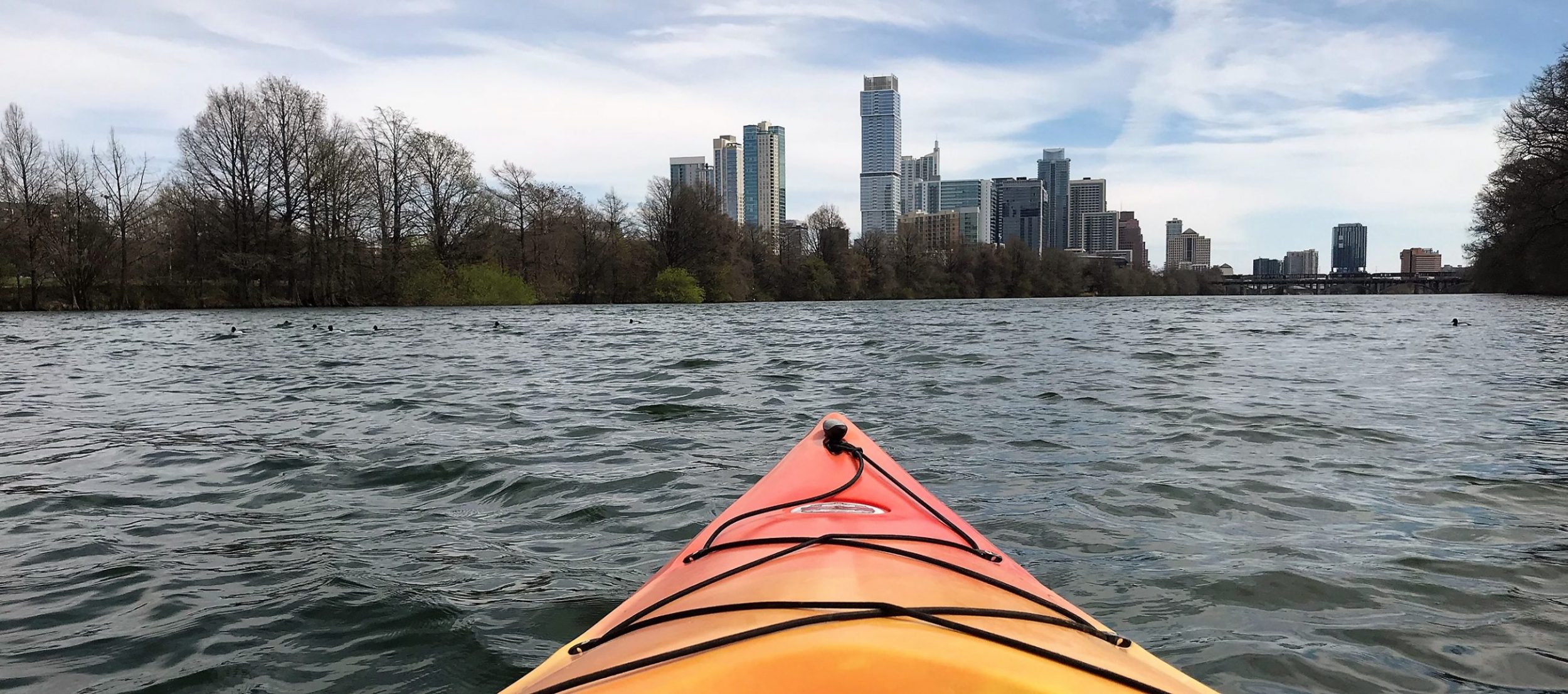 A kayak faces the skyline of downtown Austin.