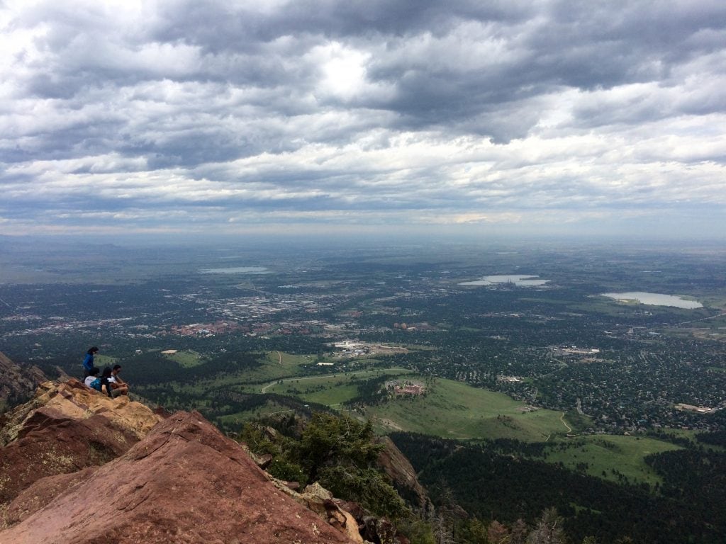 The City of Boulder sprawls out below the rocky summit.