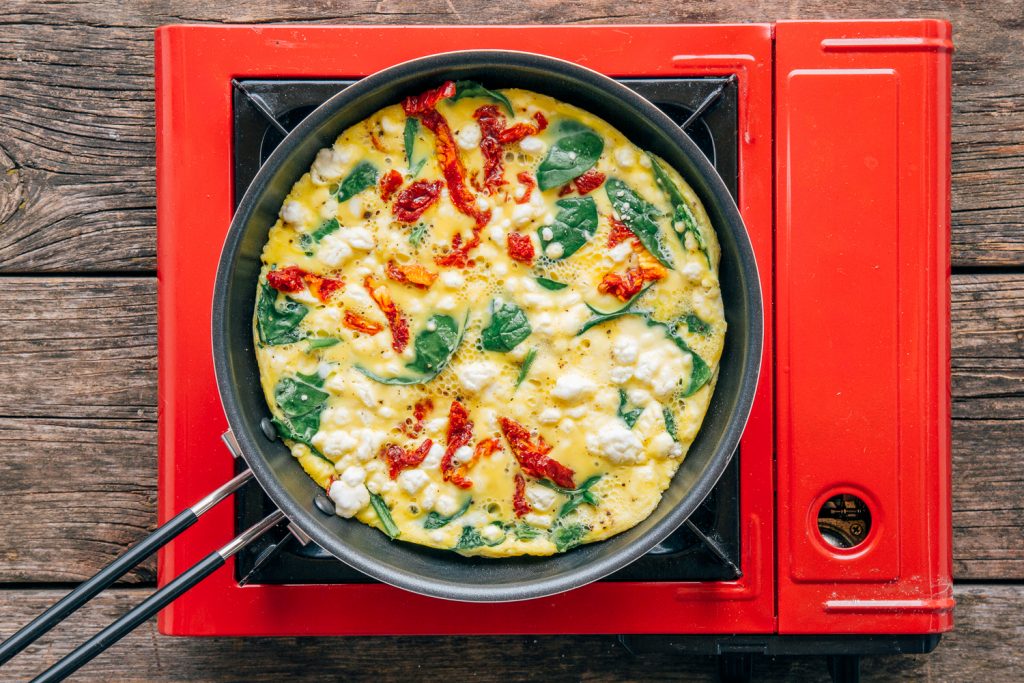 Spinach frittata cooking in skillet