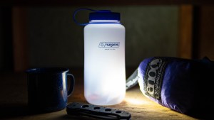 lit headlamp in Nalgene water bottle