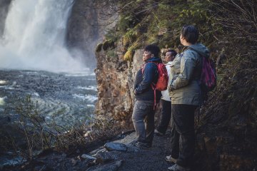 Hikers looking at a waterfall