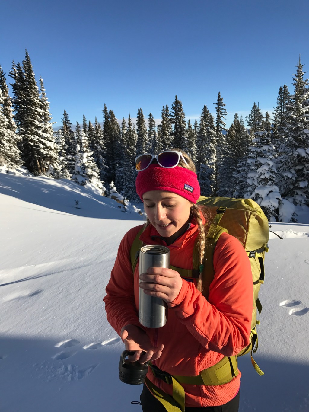 Caroline Gleich drinks warm liquid on a cold, winter day in the backcountry.