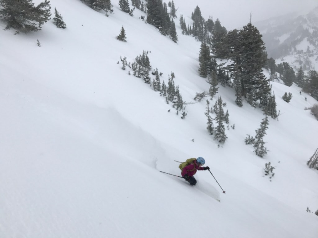 Caroline Gleich skis down a slope in the backcountry