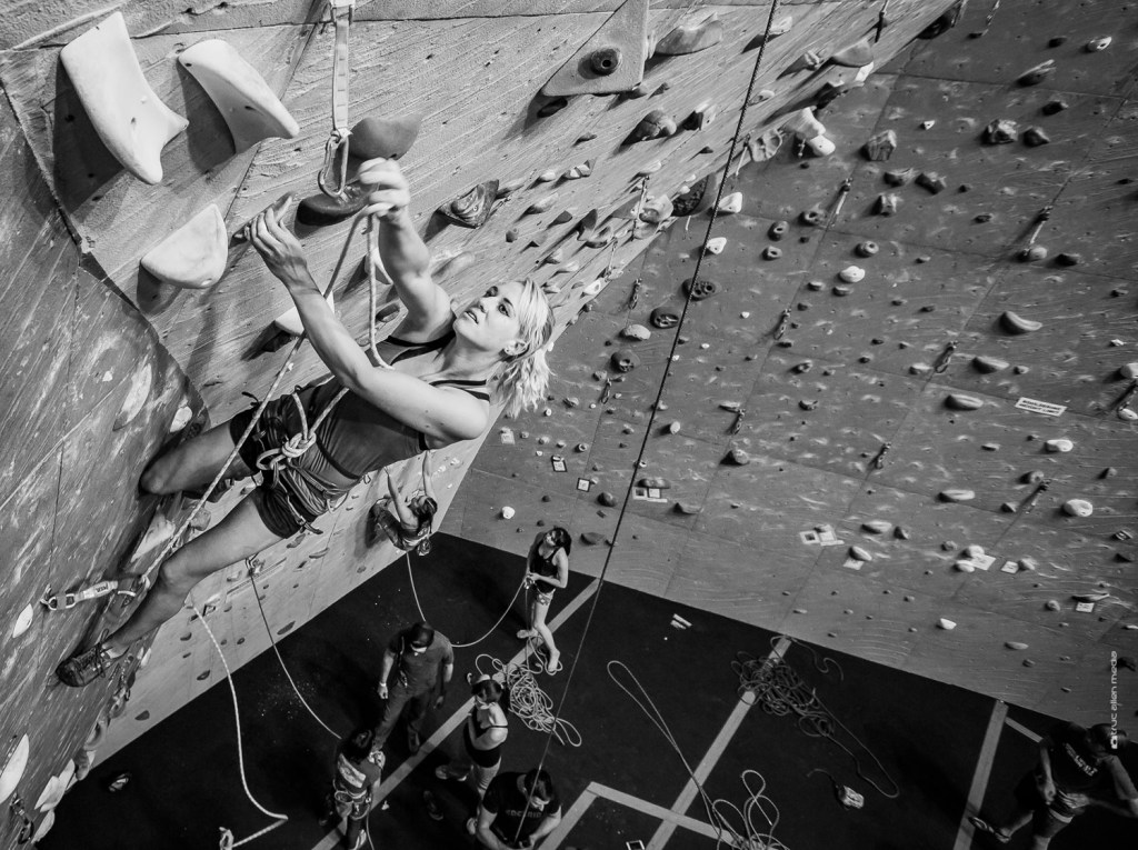 Brittany Goris rock climbing in a gym.