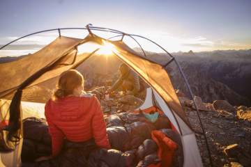 Two backpackers in a tent