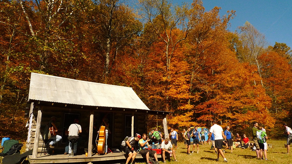 Riders relax at an old cabin 
