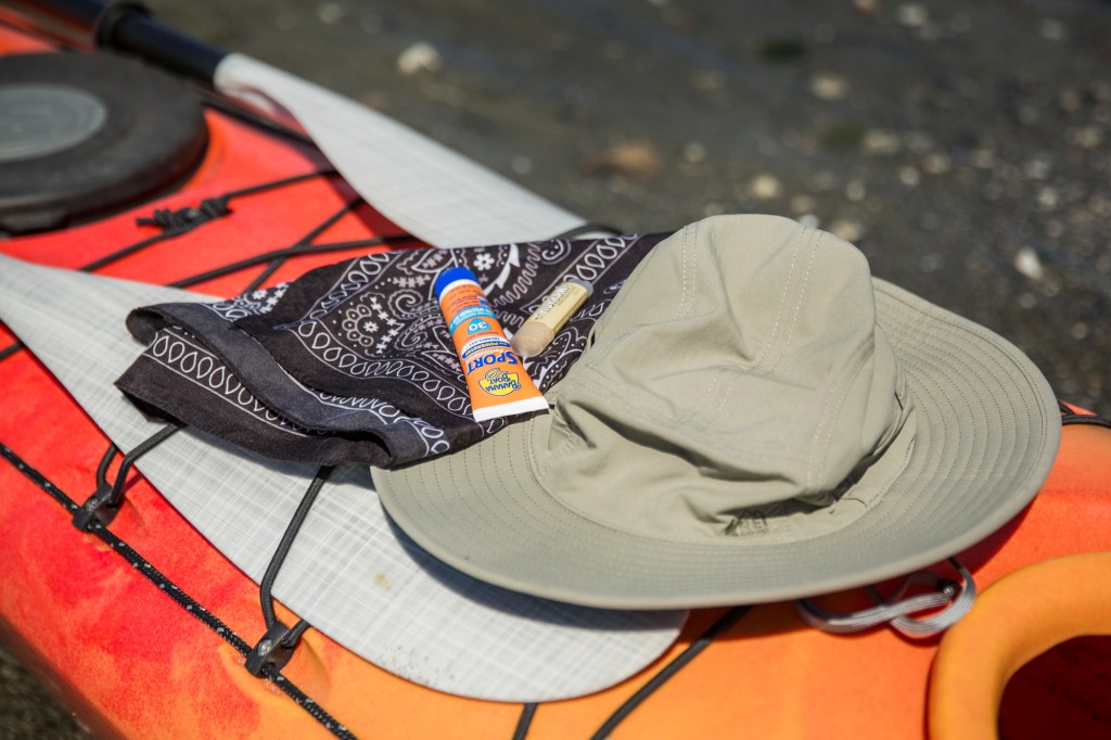 Hat, sunscreen and bandana on kayak