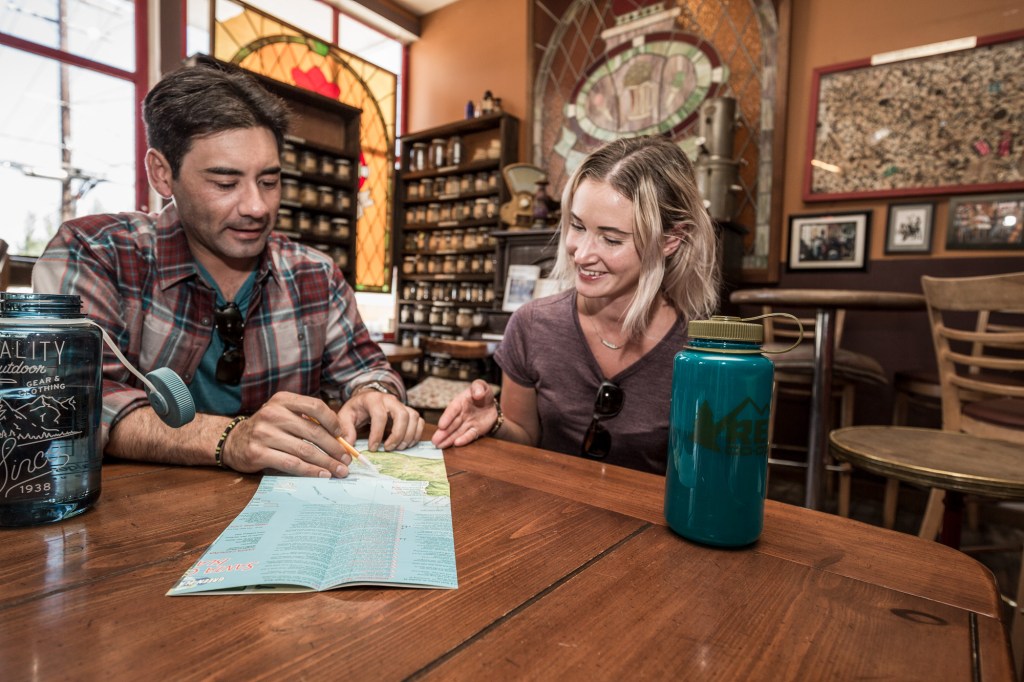 Two eager travelers, studying a map