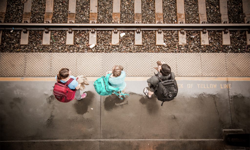 Travelers by a train