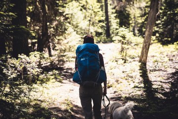 backpacker with dog in the woods