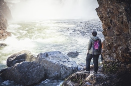 hiker looking at a waterfall