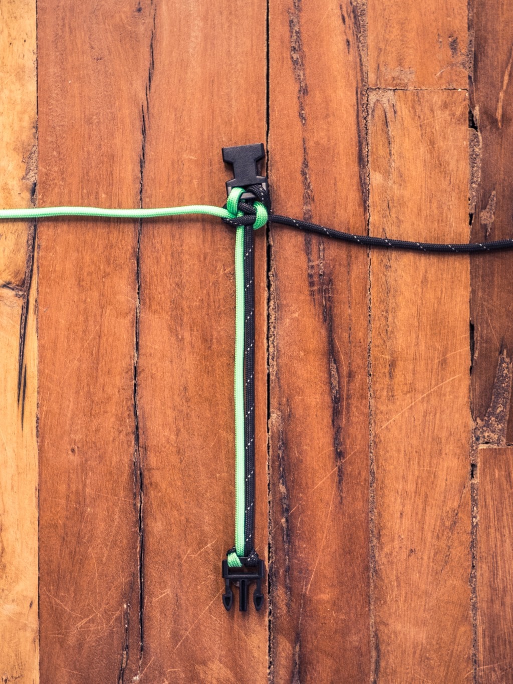 Paracord being woven together with a finished braid