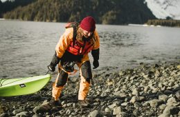 Valerie Cleland hauling a kayak on land