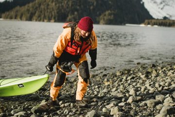Valerie Cleland hauling a kayak on land