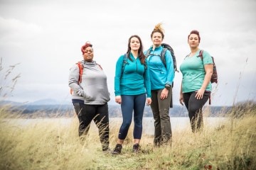 Four women standing in a field