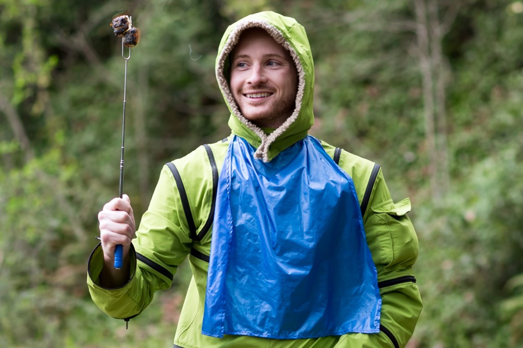 Man in ZipAll suit holding a roasting stick with roasting marshmallows
