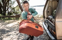 Person putting duffel in van