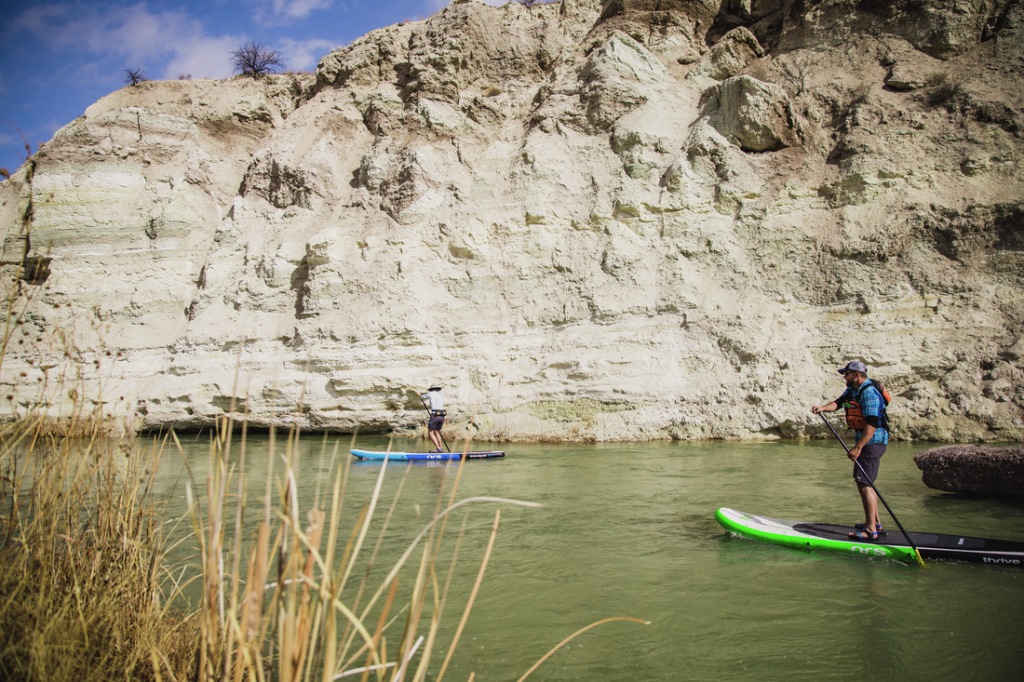 Two people paddling a river