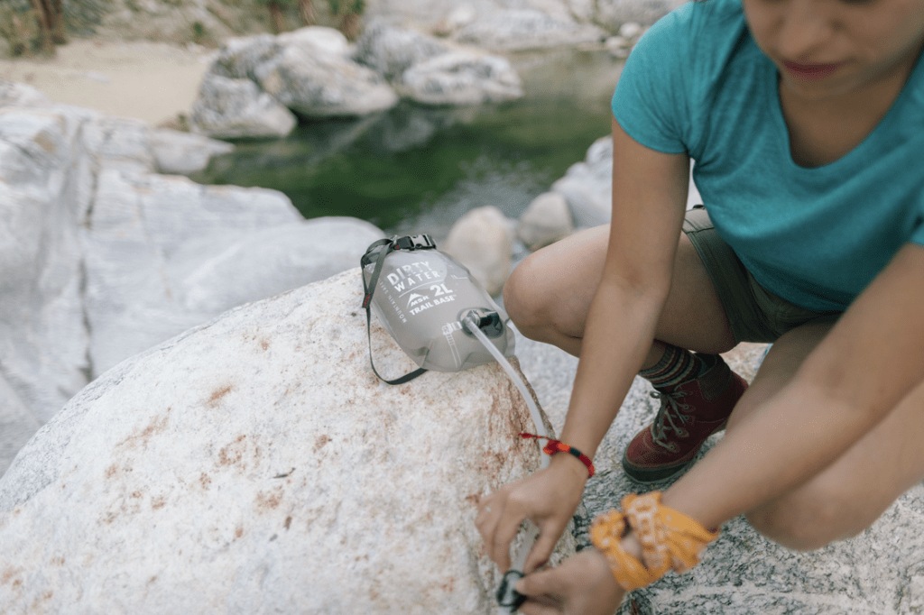 Hiker filtering water