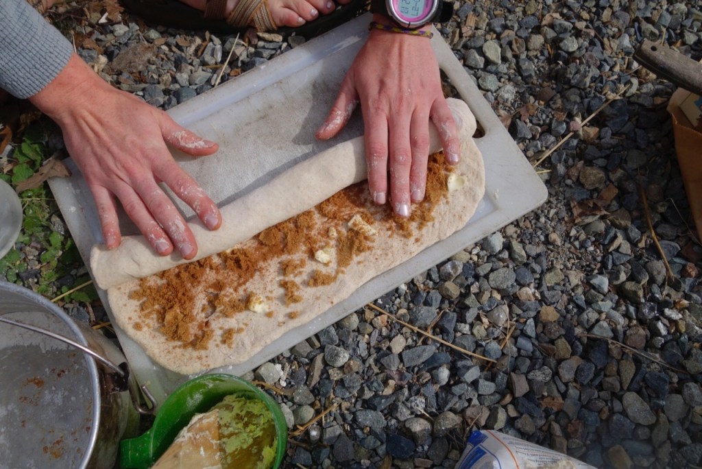 Rolling the cinnamon rolls lengthwise.