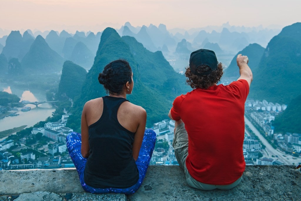 Couple enjoying morning view over Karst Mountains of Guangxi and Yangshuo, China (Photo Credit: Getty Images)