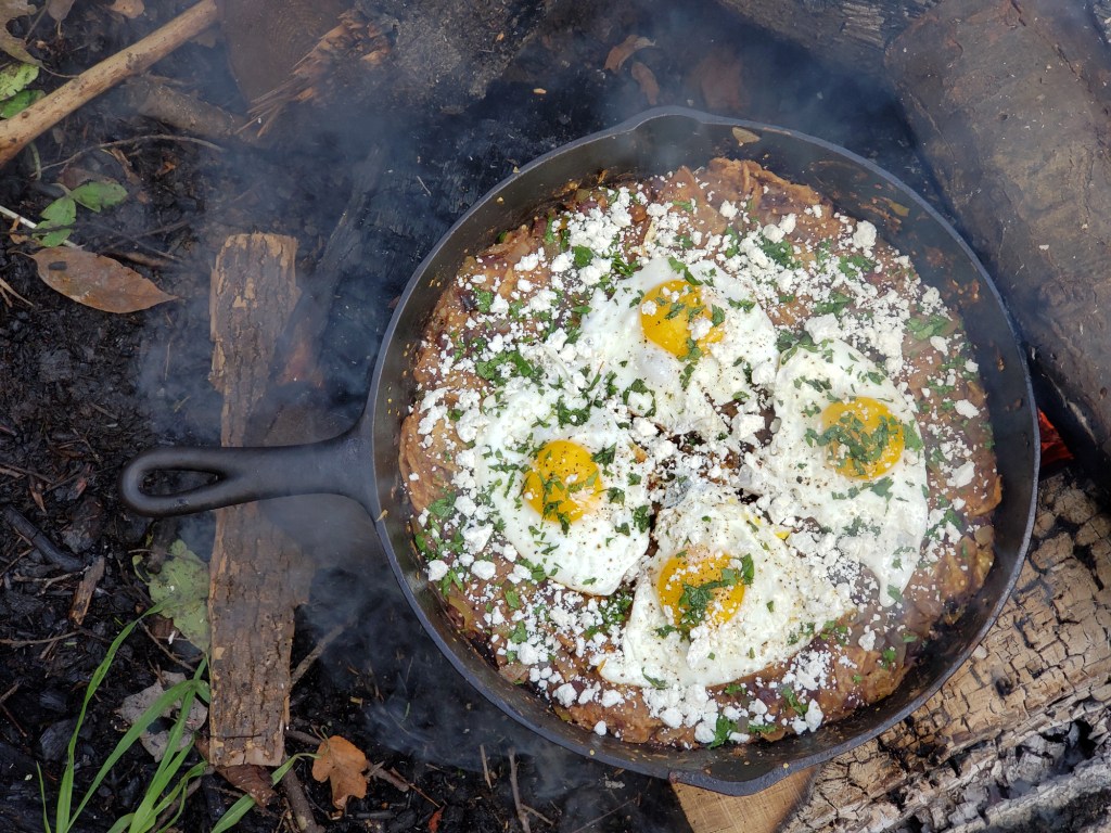A cast iron pan with freshly cooked chilaquiles.